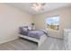 Cozy bedroom with a ceiling fan, neutral walls, and a bright window view at 556 Rachael Pl, Castle Pines, CO 80108