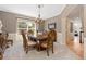 Elegant dining room with chandelier, large window, and ornate wooden table and chairs at 556 Rachael Pl, Castle Pines, CO 80108