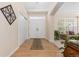 Bright foyer with hardwood floors, closet, double doors, and view of living room at 556 Rachael Pl, Castle Pines, CO 80108