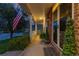 Cozy front porch features brick wall, 'Welcome' doormat, and green plants in planters at 556 Rachael Pl, Castle Pines, CO 80108