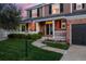 Inviting front yard with lush lawn, flower bed, sidewalk, and covered porch with columns at 556 Rachael Pl, Castle Pines, CO 80108