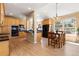 Spacious kitchen featuring wood cabinets, granite countertops, stainless steel appliances, and breakfast nook with large windows at 556 Rachael Pl, Castle Pines, CO 80108