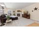Cozy living room with fireplace, large windows, a comfortable sofa and neutral carpet at 556 Rachael Pl, Castle Pines, CO 80108