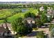 Aerial view of neighborhood, golf course, and beautiful home at 8425 Green Island Cir, Lone Tree, CO 80124