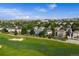 Beautiful aerial view of homes overlooking the golf course, set against a backdrop of city skyline at 8425 Green Island Cir, Lone Tree, CO 80124