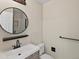Bathroom featuring a single sink vanity with round framed mirror at 8425 Green Island Cir, Lone Tree, CO 80124