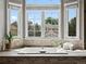 A soaking tub with a bay window offers serene backyard views in this primary bathroom at 8425 Green Island Cir, Lone Tree, CO 80124