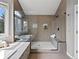 The walk-in shower has neutral toned tile, a bench, and a window for natural light at 8425 Green Island Cir, Lone Tree, CO 80124