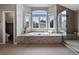 This primary bath boasts a soaking tub with bay window and a glass enclosed shower at 8425 Green Island Cir, Lone Tree, CO 80124