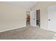 Bedroom with doors leading to bathroom and hallway with decorative railing at 8425 Green Island Cir, Lone Tree, CO 80124