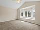 Bright bedroom with a large bay window and neutral carpeting at 8425 Green Island Cir, Lone Tree, CO 80124