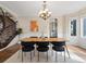 Bright dining room featuring a modern chandelier, wainscoting, and views of the staircase and kitchen at 8425 Green Island Cir, Lone Tree, CO 80124