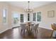 Bright dining area with hardwood floors, chandelier, and a door leading to the backyard at 8425 Green Island Cir, Lone Tree, CO 80124