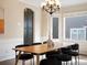 Bright dining room featuring a modern chandelier, wainscoting, and a view of the neighborhood at 8425 Green Island Cir, Lone Tree, CO 80124