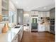 Bright kitchen with stainless steel refrigerator, white countertops, and dark wood floors at 8425 Green Island Cir, Lone Tree, CO 80124