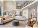 Bright living room with a high ceiling, stylish furniture, and open layout to kitchen at 8425 Green Island Cir, Lone Tree, CO 80124