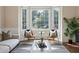 Cozy living room featuring large windows, comfortable seating, and a view of the yard at 8425 Green Island Cir, Lone Tree, CO 80124