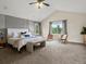 Spacious main bedroom featuring vaulted ceilings, carpet floors, large windows, and a sitting area at 8425 Green Island Cir, Lone Tree, CO 80124