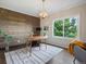 Modern office with wood paneled wall, hardwood floors, and large window at 8425 Green Island Cir, Lone Tree, CO 80124