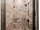 Beautifully tiled walk-in shower with multiple shower heads and decorative mosaic floor at 8425 Green Island Cir, Lone Tree, CO 80124