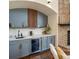 Inviting wet bar area featuring gray cabinets, a wine fridge, quartz counters, and brick fireplace at 8425 Green Island Cir, Lone Tree, CO 80124