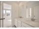 Bathroom with double vanity and view to bedroom at 5581 Wisteria Ave, Firestone, CO 80504