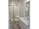 Clean bathroom with shower/tub combo, white vanity, and marble-look tile floor at 5581 Wisteria Ave, Firestone, CO 80504