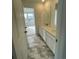 Clean bathroom with double vanity and marble-look flooring at 5581 Wisteria Ave, Firestone, CO 80504