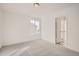 Simple bedroom with gray carpet and large window at 5581 Wisteria Ave, Firestone, CO 80504