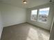 Well-lit bedroom featuring carpeted floors and large windows at 5581 Wisteria Ave, Firestone, CO 80504