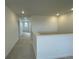 Upstairs hallway with carpet and access to bedrooms at 5581 Wisteria Ave, Firestone, CO 80504