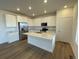 Modern kitchen featuring white cabinets, quartz countertops, and stainless steel appliances at 5581 Wisteria Ave, Firestone, CO 80504