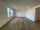 Large living room with light wood flooring and neutral walls at 5581 Wisteria Ave, Firestone, CO 80504