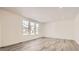 Bright living room with hardwood floors and large windows at 5581 Wisteria Ave, Firestone, CO 80504