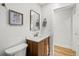 Bathroom with a wooden vanity, white countertop, mirror, and framed floral picture at 2341 Poze Blvd, Thornton, CO 80229