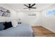 Bedroom with hardwood floors, a ceiling fan, a bed, and a window at 2341 Poze Blvd, Thornton, CO 80229