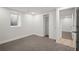 Bedroom with neutral carpet and doorway to another room. Features closet, trim, and window at 2341 Poze Blvd, Thornton, CO 80229