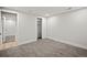 Bedroom with neutral carpet and doorway to another room. Features closet and trim at 2341 Poze Blvd, Thornton, CO 80229