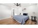 Bedroom with wood floors, a ceiling fan, and a view to an adjacent bathroom at 2341 Poze Blvd, Thornton, CO 80229