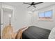 Bedroom featuring light wood floors, a ceiling fan, a bright window, closet, and doorway at 2341 Poze Blvd, Thornton, CO 80229