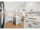 Beautiful kitchen with an island, stainless steel appliances, and a view into the living area at 2341 Poze Blvd, Thornton, CO 80229