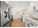 Contemporary kitchen featuring stainless steel appliances, white cabinets, and sleek countertops at 2341 Poze Blvd, Thornton, CO 80229