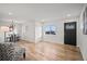 Bright living room featuring hardwood floors, modern lighting, and a stylish accent chair at 2341 Poze Blvd, Thornton, CO 80229