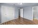 Bedroom with wood floors, closet, and a view of the attached bathroom at 1155 S Fairplay Cir # D, Aurora, CO 80012