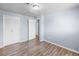 A bright bedroom features wood-look flooring, a double closet, and light-blue walls at 1155 S Fairplay Cir # D, Aurora, CO 80012