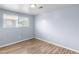 Bedroom with neutral paint, wood-look flooring, and window with natural light at 1155 S Fairplay Cir # D, Aurora, CO 80012