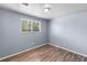 Bedroom with window, light blue wall paint, and wood-look laminate flooring at 1155 S Fairplay Cir # D, Aurora, CO 80012