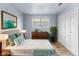 Bedroom with a light blue accent wall, wood floors, a window, and a closet at 1155 S Fairplay Cir # D, Aurora, CO 80012