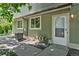 A close up view of the building's exterior with front door, meter and A/C unit at 1155 S Fairplay Cir # D, Aurora, CO 80012