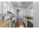 Galley kitchen featuring white cabinets, modern appliances, and wood-look flooring at 1155 S Fairplay Cir # D, Aurora, CO 80012